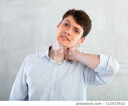 Man experiencing acute pain in his neck 112017632
