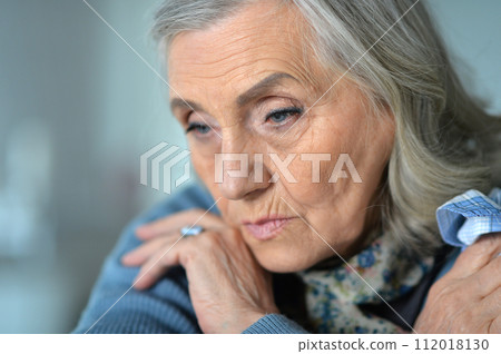 Portrait of sick senior woman at home 112018130