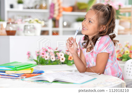 Portrait of happy schoolgirl studying at home Portrait of happy schoolgirl studying at home 112018210