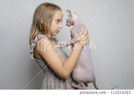 Friends. Young child girl and cat pet on gray studio wall banner background 112018263