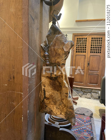 Old ancient winesking bag for wine hanging on the wall 112018275