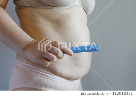 Medicine, overweight, weight loss and diet concept. Female stomanch and semaglutide Medicine, overweight, weight loss and diet concept. Female stomanch and semaglutide 112018331