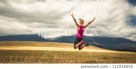 Young woman jumping in the mountains Young woman jumping in the mountains 112018858