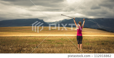 Young woman hiking in the mountains Young woman hiking in the mountains 112018862