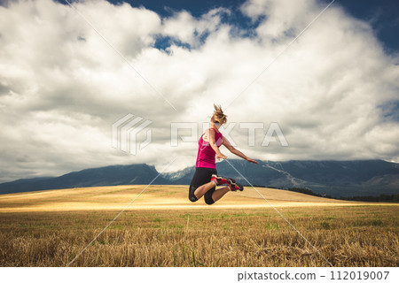 Young woman jumping in the mountains Young woman jumping in the mountains 112019007