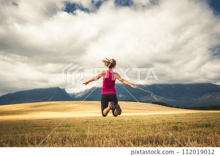 Young woman jumping in the mountains Young woman jumping in the mountains 112019012