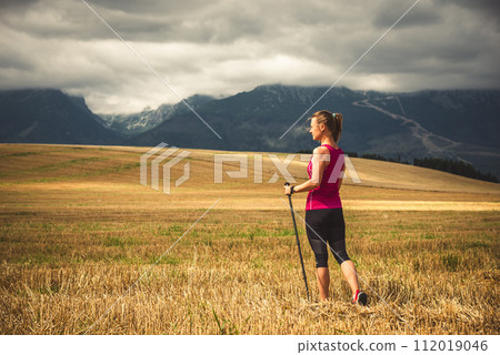 Young woman hiking in the mountains 112019046