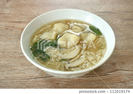 rice porridge with bass fish and slice mushroom topping celery on bowl rice porridge with bass fish and slice mushroom topping celery on bowl 112019174