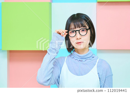 young woman wearing black-rimmed glasses 112019441