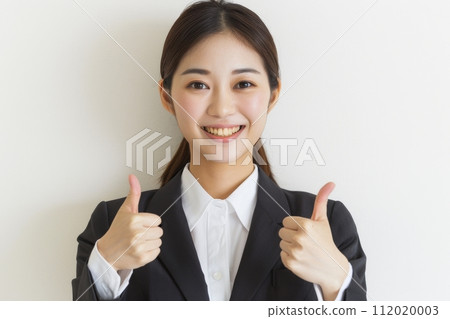 Japanese female office worker with thumbs up (white background, suit, smile) 112020003