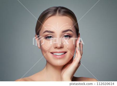 Happy woman with massage or surgery lines on her face.  112020614
