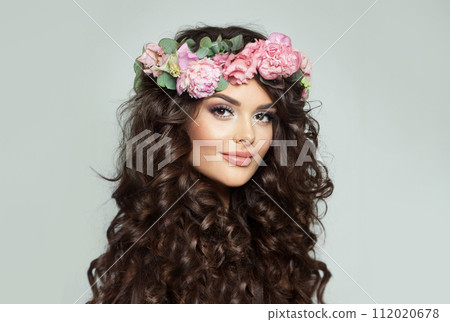 Cheerful fashion model woman with fresh skin, long dark wavy hair styling and makeup 112020678