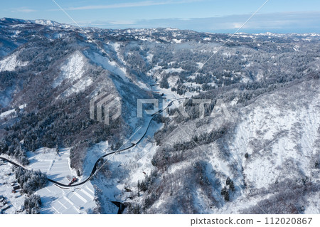 Drone photography: vast natural landscape of snow-covered countryside Drone photography: vast natural landscape of snow-covered countryside 112020867