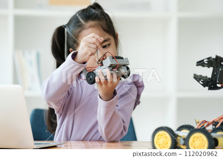 STEM education concept. Asian young girl learning robot design. 112020962
