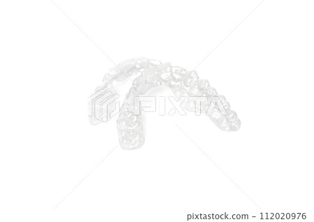 Tooth aligners, invisible orthodontics cosmetic brackets on white background, plastic braces. Tooth aligners, invisible orthodontics cosmetic brackets on white background, plastic braces. 112020976