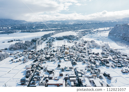 Drone photography: A residential area in a rural town covered in pure white snow 112021037