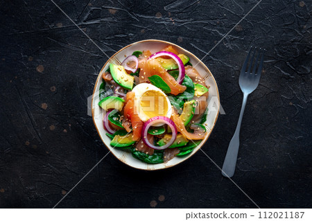 Salmon, avocado and egg salad with fresh leaves and onions Salmon, avocado and egg salad with fresh leaves and onions 112021187