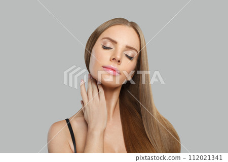 Cute glamorous woman fashion model with long straight healthy hair and makeup posing 112021341