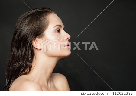 Lovely woman with massage or surgery lines on her face. Lovely woman with massage or surgery lines on her face. 112021382