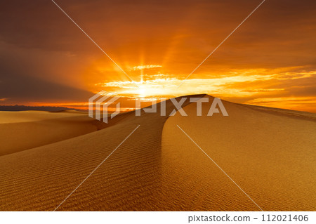 Sunset over the sand dunes in the desert. Rub' al Khali desert Sunset over the sand dunes in the desert. Rub' al Khali desert 112021406
