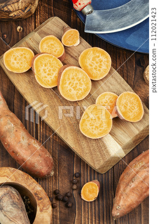 Sweet potatoes on wooden surface Sweet potatoes on wooden surface 112021423