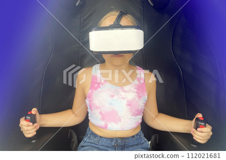 Child girl in VR glasses headset playing in virtual reality cabin Child girl in VR glasses headset playing in virtual reality cabin 112021681