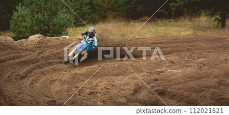 Moto cross - MX girl biker at race in Russia - a sharp turn and the spray of dirt Moto cross - MX girl biker at race in Russia - a sharp turn and the spray of dirt 112021821