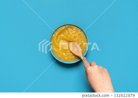 Homemade apple sauce top view on a blue background 112022879