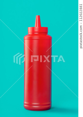 Ketchup plastic bottle isolated on a blue background 112022881