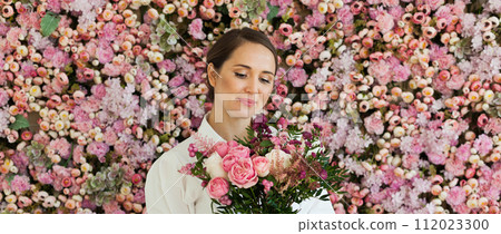Beautiful healthy woman smiling and holding colorful pink color flower bouquet Beautiful healthy woman smiling and holding colorful pink color flower bouquet 112023300