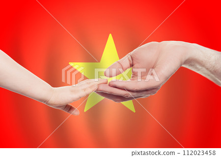 Vietnamese baby and parent hands on the background of flag of Vietnam 112023458
