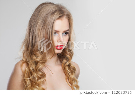 Perfect blonde model woman with perfect hairstyle, fresh clear skin and makeup on white background.  112023755