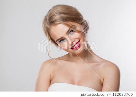 Excited blonde model woman with perfect hairstyle, fresh clear skin and makeup on white background. Excited blonde model woman with perfect hairstyle, fresh clear skin and makeup on white background. 112023760