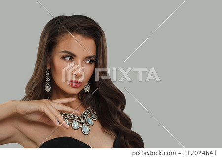 Glorious jewelry model woman with dark brown hair and shiny fresh skin wearing diamond earring Glorious jewelry model woman with dark brown hair and shiny fresh skin wearing diamond earring 112024641