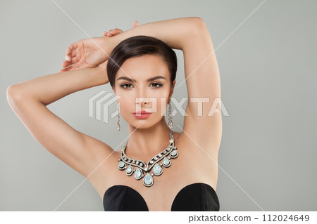 Perfect sensual model woman in diamond jewelry earring and necklace posing  112024649