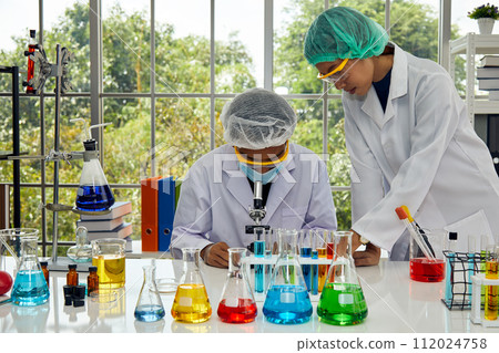 Two Scientists deeply involved Intensive Scientific Research in modern laboratory experiment. 112024758