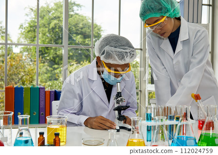 Two Intensive Scientists deeply involved Research in Modern laboratory experiment 112024759