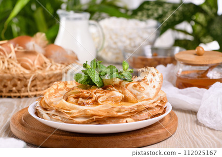Homemade thin crepe (pancakes) with honey 112025167
