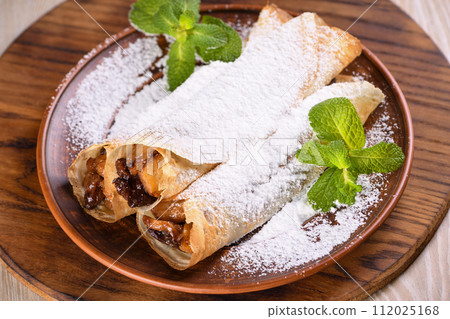 Homemade thin crepe (pancakes) with apple filling 112025168