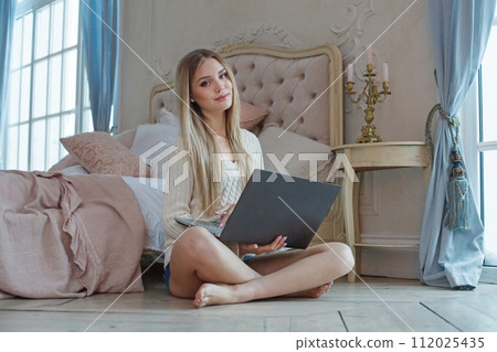 Pretty woman student with laptop at home Pretty woman student with laptop at home 112025435