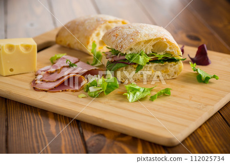 sandwich with sausage and herbs 112025734