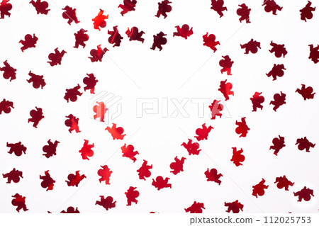 Heart made of a small cupids on white background. Copy space. Flat lay 112025753