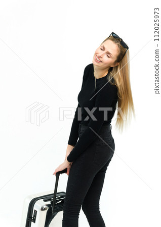Pretty young woman pulling her heavy suitcase on white background. 112025973
