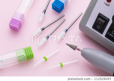 Various ceramic cutters for hardware manicure and pedicure on a colored background Various ceramic cutters for hardware manicure and pedicure on a colored background 112026045