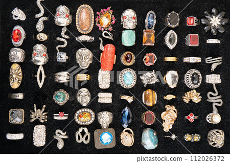 Worn rings and gemstone rings of various shapes selling at a flea market Worn rings and gemstone rings of various shapes selling at a flea market 112026372