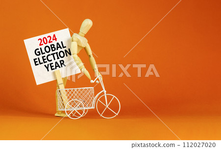 2024 global election year symbol. Concept words 2024 global election year on beautiful white paper on clothespin. Beautiful orange background. Business 2024 global election year concept. Copy space 2024 global election year symbol. Concept words 2024 global election year on beautiful white paper on clothespin. Beautiful orange background. Business 2024 global election year concept. Copy space 112027020