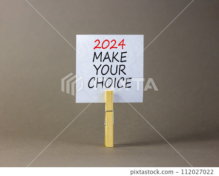 2024 Make your choice symbol. Concept words 2024 Make your choice on beautiful white paper on clothespin. Beautiful grey background. Business 2024 Make your choice concept. Copy space 2024 Make your choice symbol. Concept words 2024 Make your choice on beautiful white paper on clothespin. Beautiful grey background. Business 2024 Make your choice concept. Copy space 112027022