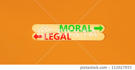 Moral or legal symbol. Concept word Moral or Legal on beautiful wooden stick. Beautiful orange table orange background. Business and moral or legal concept. Copy space. 112027055