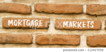 Mortgage markets symbol. Concept words Mortgage markets on beautiful brown brick wall. Beautiful brown brick wall background. Business mortgage markets concept. Copy space. Mortgage markets symbol. Concept words Mortgage markets on beautiful brown brick wall. Beautiful brown brick wall background. Business mortgage markets concept. Copy space. 112027056