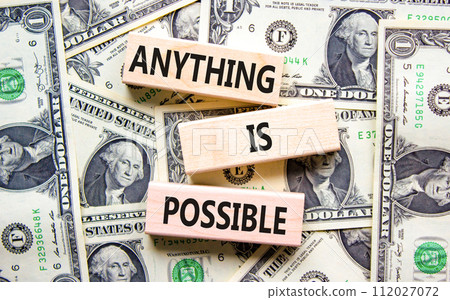Anything is possible symbol. Concept words Anything is possible on beautiful wooden blocks. Dollar bills. Beautiful dollar bills background. Business anything possible concept. Copy space. 112027072
